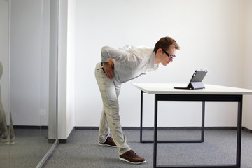 exercise durrng office work - man with tablet in his office