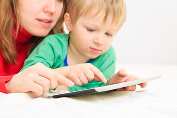 mother and son with touch pad at home