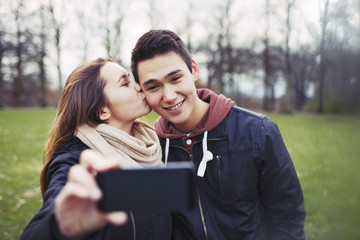 Fototapeta premium Loving teenage couple taking self portrait