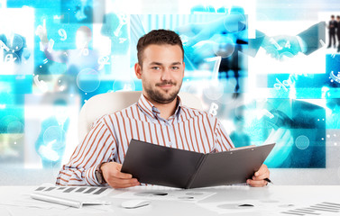 Business person at desk with modern tech images at background