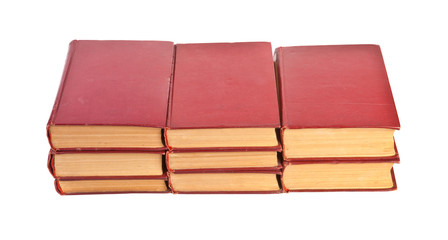 three piles of books on a white background