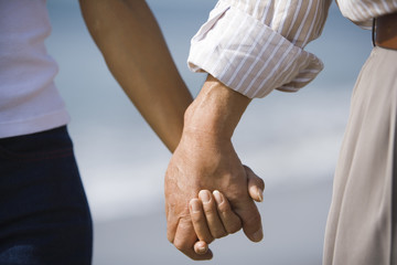 hands of husband and wife holding