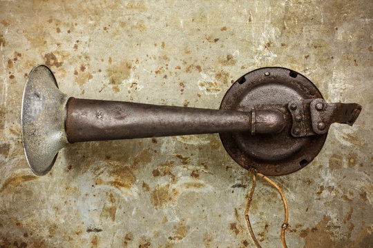 Old car horn on a steel rusty background