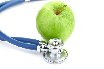 Medical stethoscope and apple isolated on white