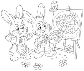 Easter Bunnies drawing a decorated Easter egg