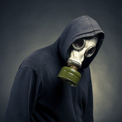 A man in a gas mask on a dark background