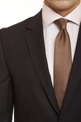 brown suit with brown tie