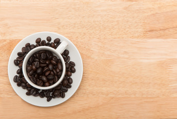 coffee cup with spilled coffee beans, background