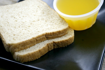 bread and orange juice on dish
