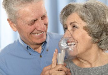 Elderly couple with inhaler