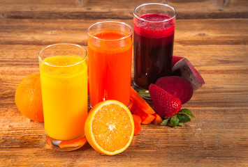 Fresh vegetable and fruits juices on wood plant 