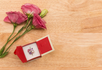 gift with red flower on wooden vintage table with copy space