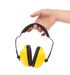 Hands holds working protective headphones.