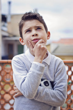 Ni&ntilde;o pensando y mirando para arriba