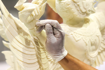 Close up of hand carving white chocolate
