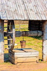 outdated wooden well with large wheel