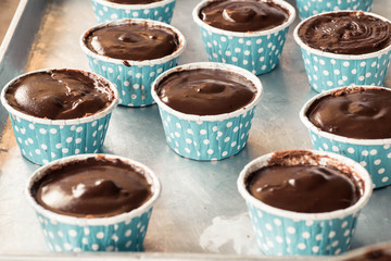 Chocolate cake batter in a cupcake case before baking