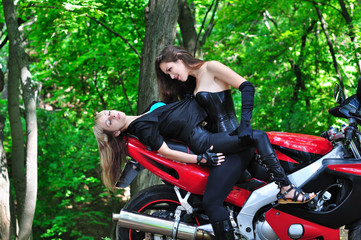 Obraz premium Two passionate girl on sports bike