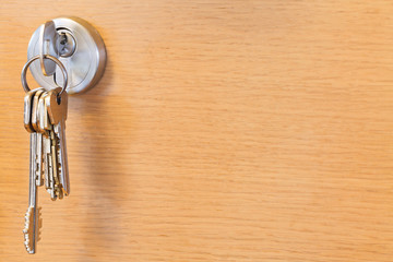 bunch of keys in lock of wooden door