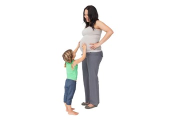 Fototapeta premium Little girl touching her mothers baby bump