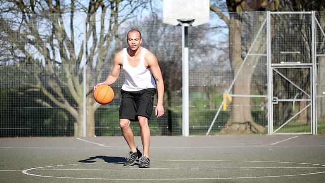 Smiling Basketball Player bouncing the ball
