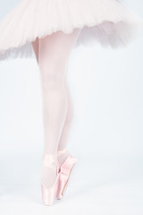 A ballet dancer standing on toes while dancing artistic conversi