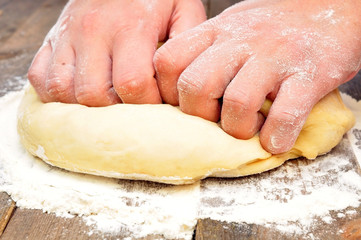 female hand kneads dough