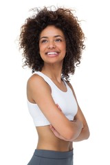 Fototapeta na wymiar Smiling fit young woman with arms crossed