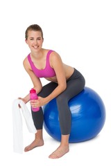 Portrait of a fit woman sitting on exercise ball