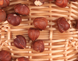 Close up of hazel nuts on a wicker basket.