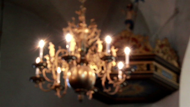 Elegant lighted chandelier hanging in church