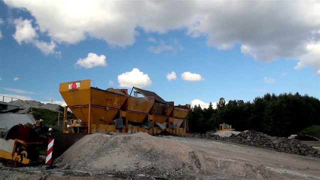 Four gravel buckets in the site and an operating bulldozer