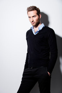 Fashion portrait of young man in black pullover.