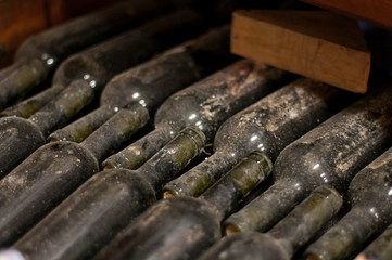 Stack of Aging Red Wine Bottles
