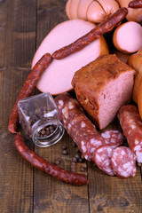 Lot of different sausages on wooden table close-up