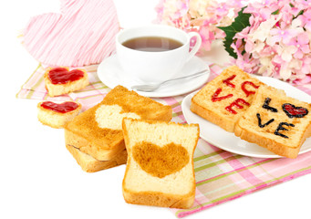 Delicious toast with jam and cup of tea on table close-up