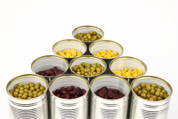 The tins with peas, red bean, corn on the white background