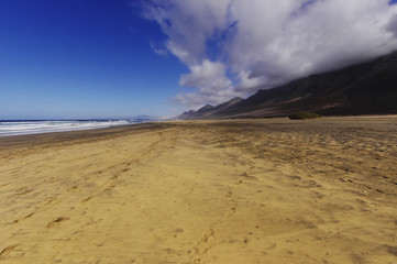 Cofete beach and volcanic mountains view on Jandia peninsula, Fu