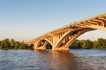 Concrete bridge across a river at sunset