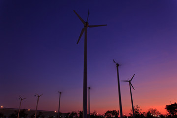 Obraz premium Wind turbines at sunset