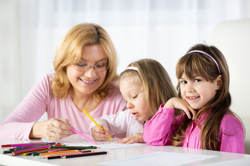 Fototapeta premium Two little girls drawing with colored pencils