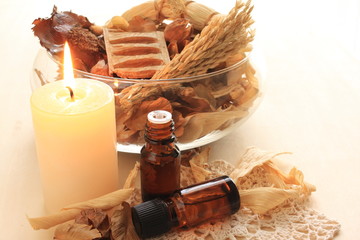 dried plant and candle with essential oil
