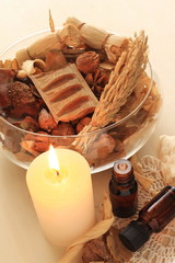 dried plant and candle with essential oil