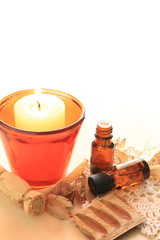 dried plant and candle with essential oil