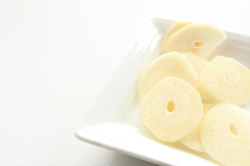 sliced garlic on white dish with copy space