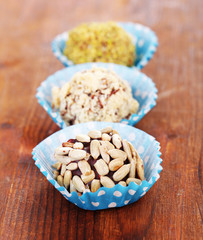 Set of chocolate candies, on wooden background