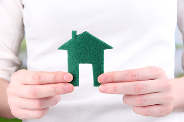 Little paper house in hand close-up