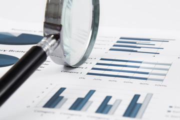 magnifying glass on the business report
