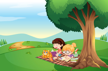 Fototapeta na wymiar Kids reading under the tree with a cat