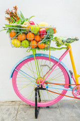 Fototapeta na wymiar Bicycle with basket fruit and flower